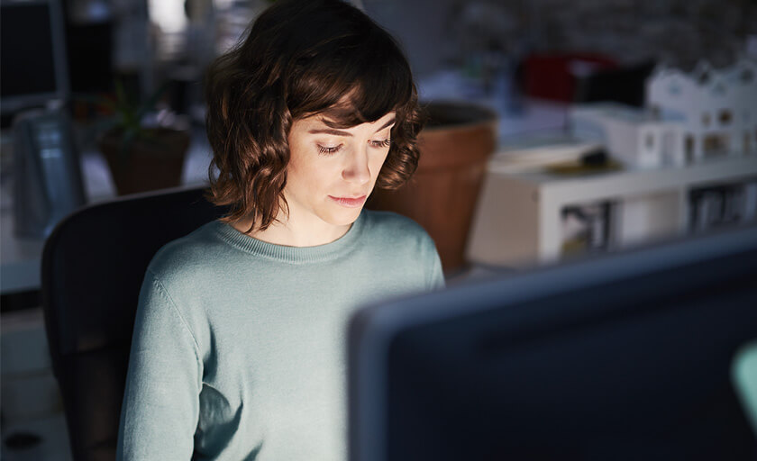 Woman on computer searching for cybersecurity tools